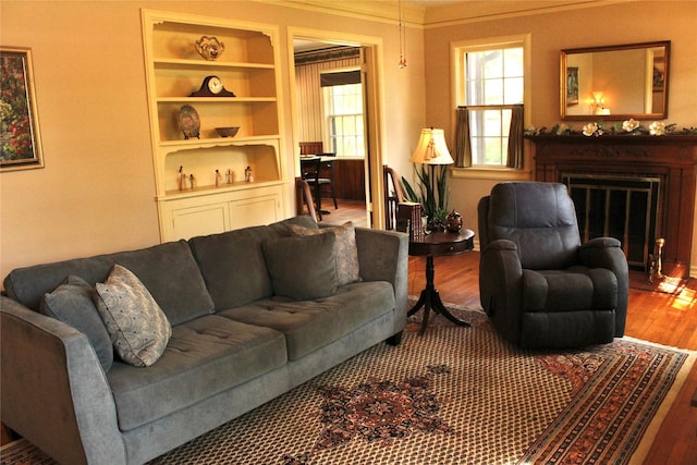 423 S O Connor Rd, Irving, TX 75060 - living room featuring a fireplace with flush hearth, built in features, and wood finished floors