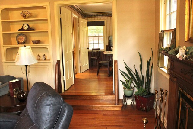 423 S O Connor Rd, Irving, TX 75060 - corridor featuring built in features, ornamental molding, and dark wood-style floors