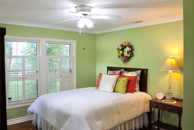 423 S O Connor Rd, Irving, TX 75060 - bedroom with crown molding, ceiling fan, baseboards, wood finished floors, and visible vents