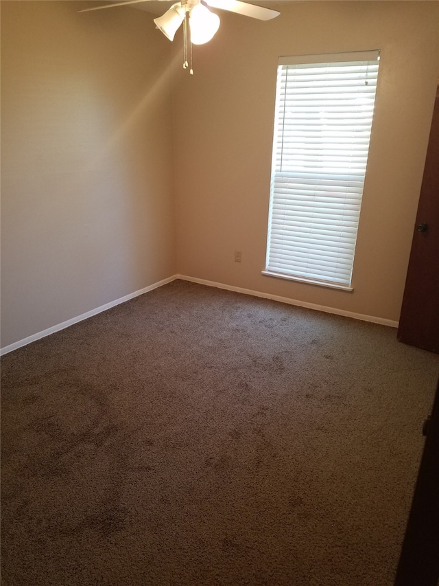 9025 Lone Oak Dr, Shreveport, LA 71118 - unfurnished room with baseboards, dark colored carpet, and a ceiling fan
