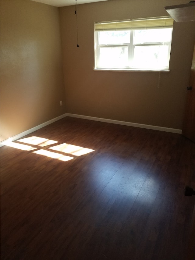 9025 Lone Oak Dr, Shreveport, LA 71118 - empty room with baseboards and dark wood-style flooring
