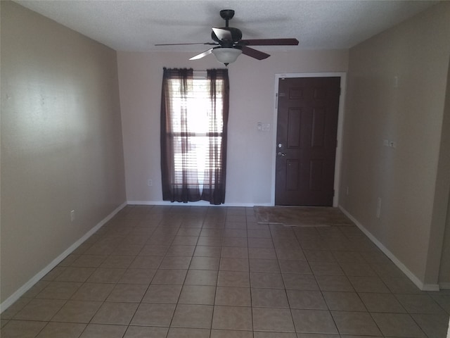 9025 Lone Oak Dr, Shreveport, LA 71118 - spare room featuring light tile patterned floors, ceiling fan, and baseboards