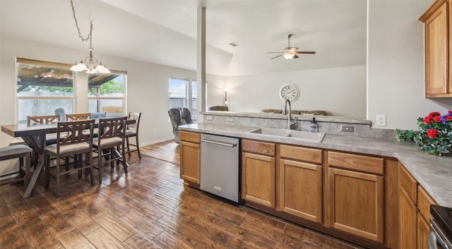 kitchen featuring vaulted ceiling, dark wood finished floors, dishwasher, a sink, and a peninsula