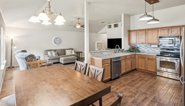 kitchen featuring backsplash, stainless steel appliances, a sink, and lofted ceiling