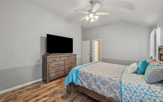 bedroom with baseboards, ceiling fan, vaulted ceiling, and wood finished floors