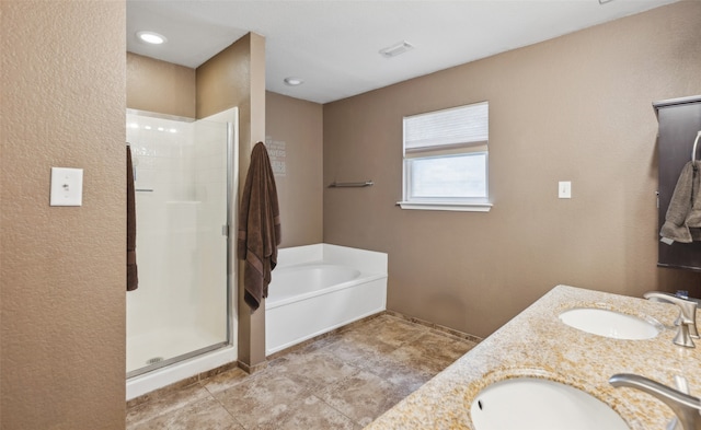 bathroom featuring visible vents, a sink, a bath, and a shower stall