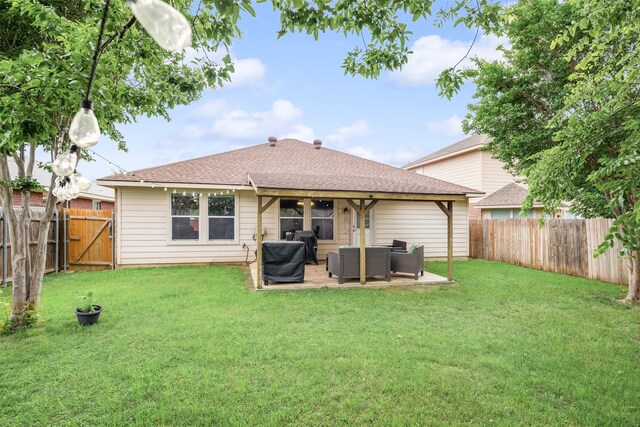 rear view of property with a lawn, outdoor lounge area, and a fenced backyard