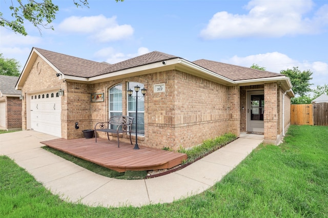 single story home featuring a garage, brick siding, fence, a front lawn, and concrete driveway