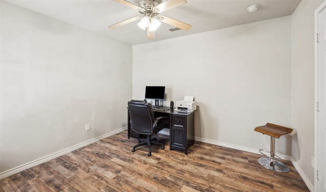 home office featuring baseboards, a ceiling fan, wood finished floors, and visible vents