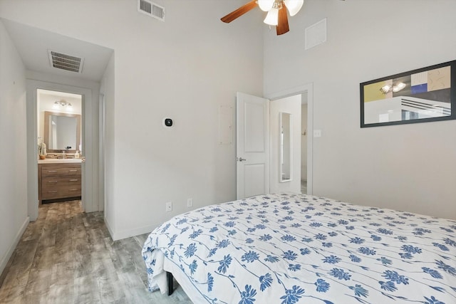 bedroom featuring wood finished floors, visible vents, and baseboards