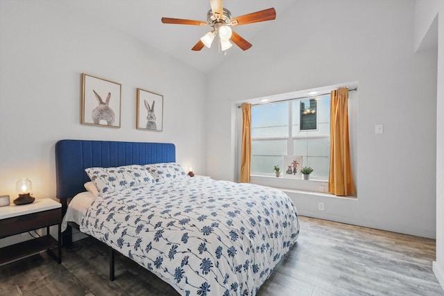 bedroom with wood finished floors, a ceiling fan, and lofted ceiling