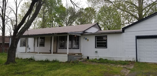 single story home with a front lawn, covered porch, and an attached garage