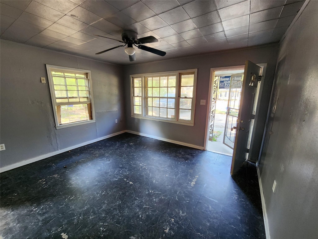 entrance foyer featuring baseboards, a ceiling fan, and plenty of natural light
