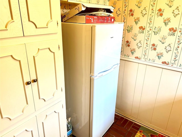 6114 Verona Ln, Shreveport, LA 71105 - detailed view of freestanding refrigerator, wallpapered walls, a wainscoted wall, and a decorative wall