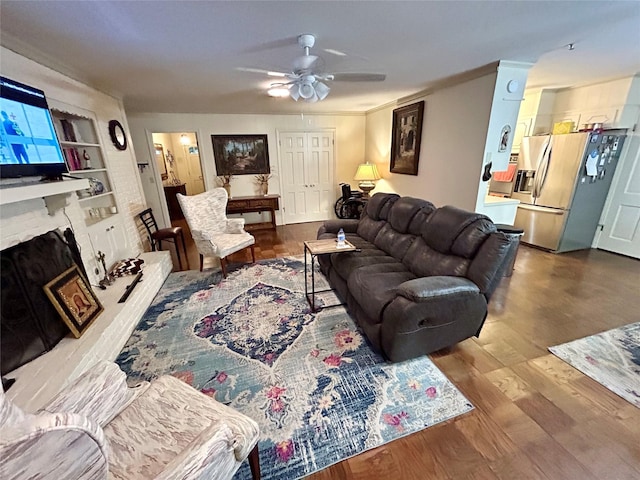 6114 Verona Ln, Shreveport, LA 71105 - living area featuring a ceiling fan, wood finished floors, a fireplace, and built in shelves