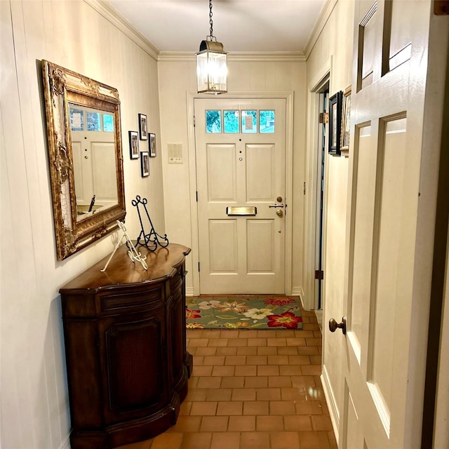6114 Verona Ln, Shreveport, LA 71105 - foyer with dark tile patterned floors, ornamental molding, and a chandelier