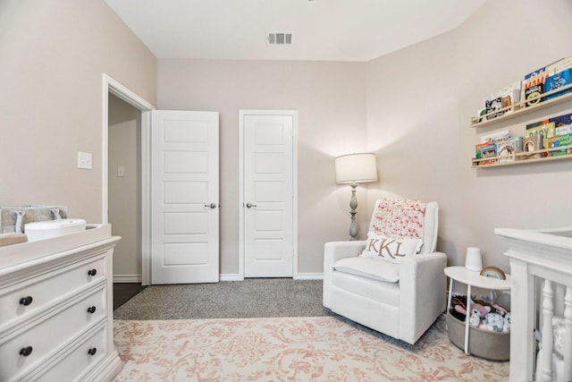 bedroom featuring visible vents, baseboards, and light colored carpet