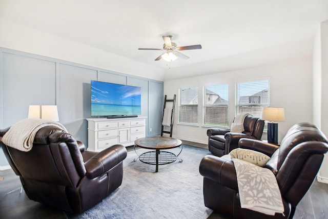 living area with a ceiling fan and wood finished floors