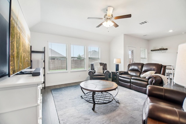 living area featuring a healthy amount of sunlight, a ceiling fan, wood finished floors, and visible vents