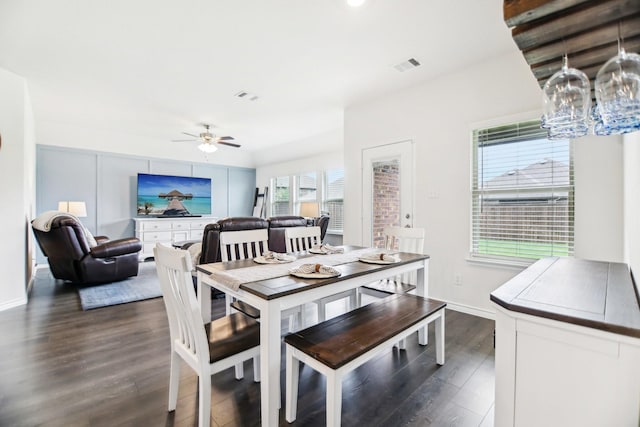 dining area featuring baseboards, ceiling fan, dark wood-style flooring, and visible vents