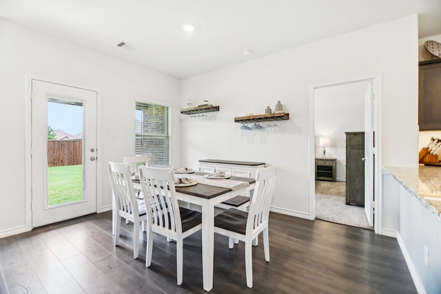 dining room with baseboards and dark wood-style floors