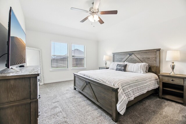 carpeted bedroom featuring baseboards and a ceiling fan