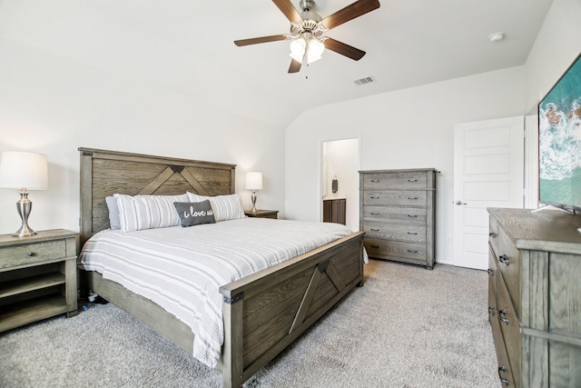 bedroom featuring visible vents, a ceiling fan, vaulted ceiling, and light colored carpet