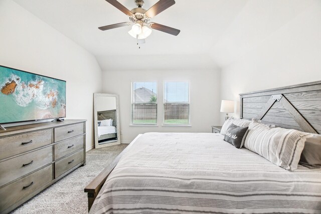 bedroom featuring ceiling fan, light carpet, and vaulted ceiling