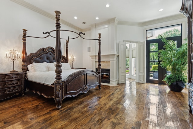 bedroom with hardwood / wood-style flooring, visible vents, recessed lighting, a fireplace, and access to outside