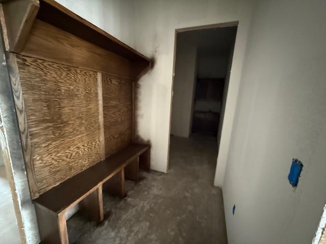 mudroom with unfinished concrete flooring