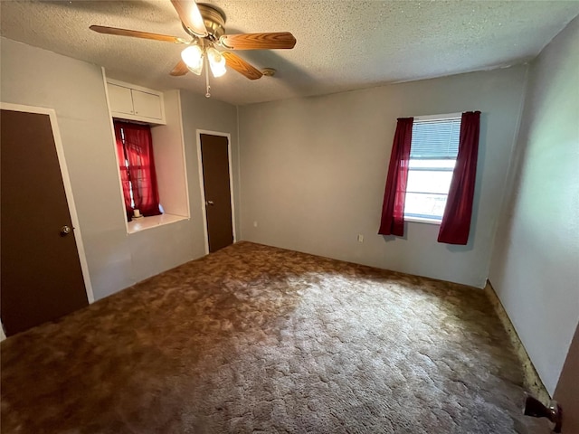 unfurnished bedroom with a textured ceiling, a ceiling fan, and carpet flooring