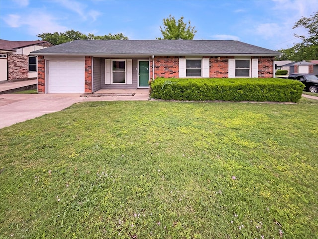 ranch-style house featuring brick siding, an attached garage, a front yard, and concrete driveway