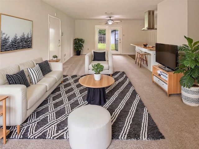 carpeted living room with ceiling fan and visible vents