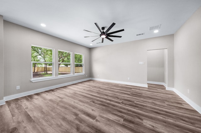 empty room featuring wood finished floors, visible vents, ceiling fan, and recessed lighting