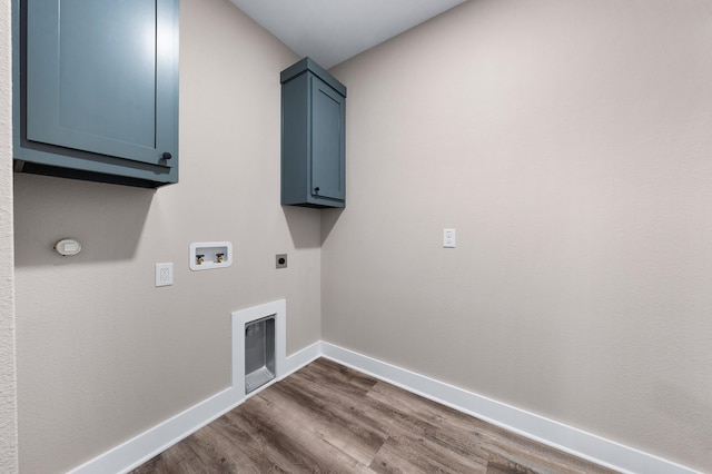 laundry area with electric dryer hookup, dark wood-style floors, baseboards, hookup for a washing machine, and cabinet space