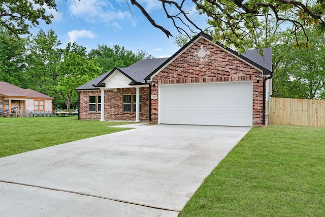 view of front of home featuring a front yard, brick siding, concrete driveway, an attached garage, and fence