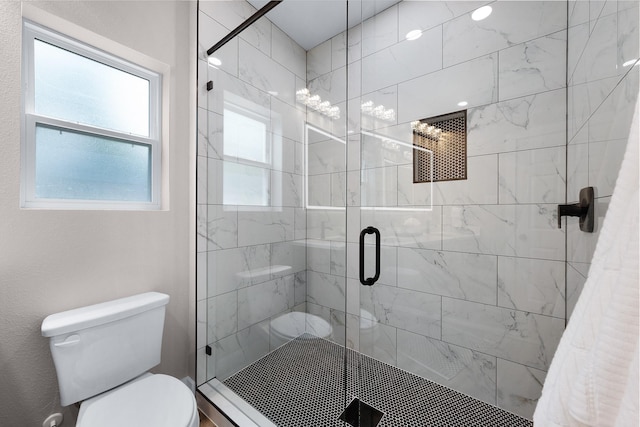 bathroom featuring toilet and a stall shower