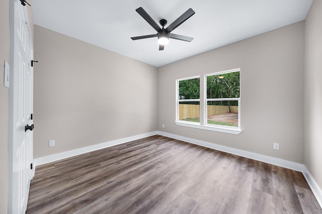 unfurnished room featuring wood finished floors, a ceiling fan, and baseboards