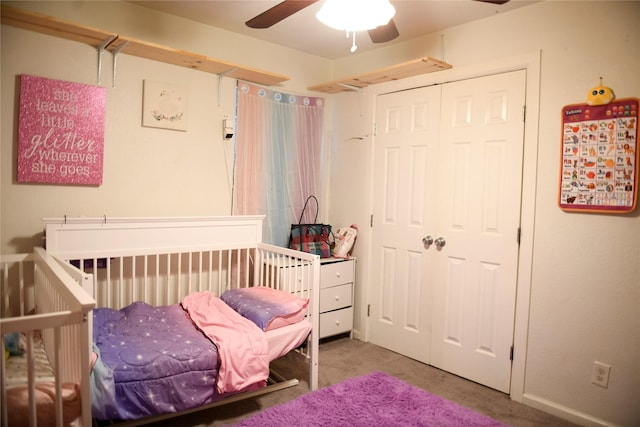 carpeted bedroom with a closet and a ceiling fan