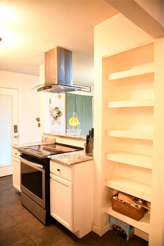 kitchen with white cabinetry, light stone counters, island exhaust hood, and electric stove