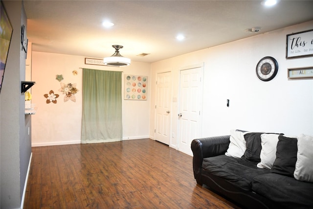sitting room featuring baseboards, dark wood-style floors, and recessed lighting