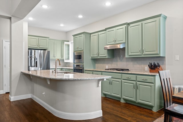 kitchen featuring under cabinet range hood, appliances with stainless steel finishes, a sink, and green cabinets