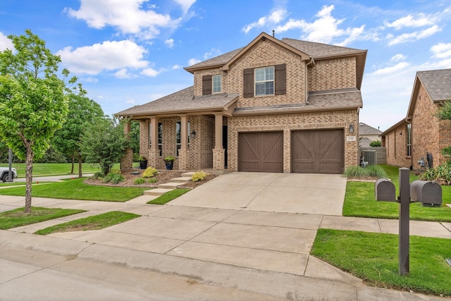 traditional home featuring a shingled roof, brick siding, a garage, a front yard, and driveway