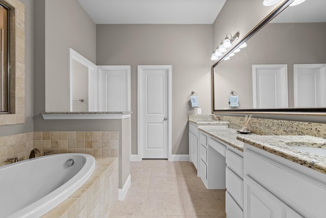 full bath featuring a garden tub, double vanity, and a sink