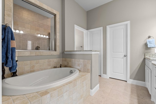 full bathroom featuring a bath, a tile shower, tile patterned floors, baseboards, and vanity
