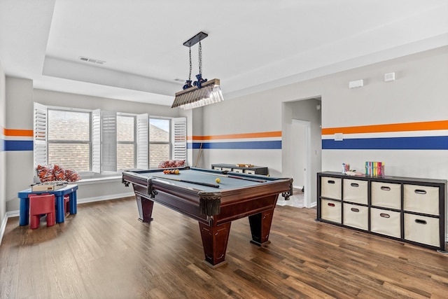 rec room with billiards, visible vents, wood finished floors, baseboards, and a tray ceiling