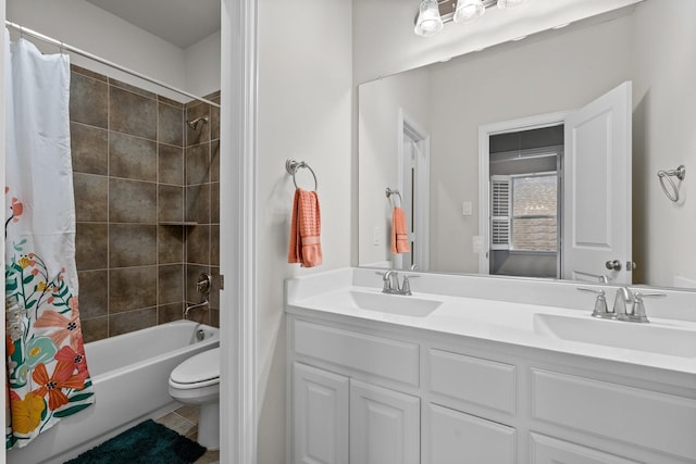 full bathroom featuring a sink, toilet, double vanity, and shower / tub combo