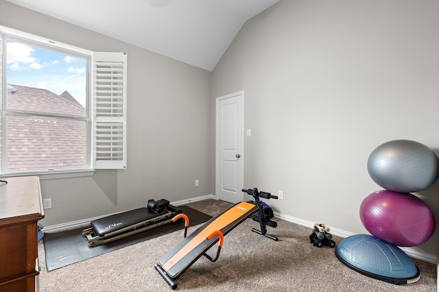 exercise room featuring carpet floors, baseboards, lofted ceiling, and a healthy amount of sunlight