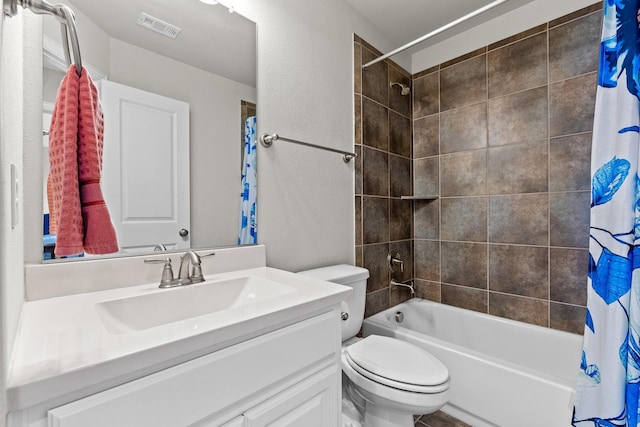 bathroom featuring a textured wall, shower / bath combo, vanity, toilet, and visible vents
