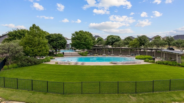 view of pool with a fenced in pool, fence, and a yard
